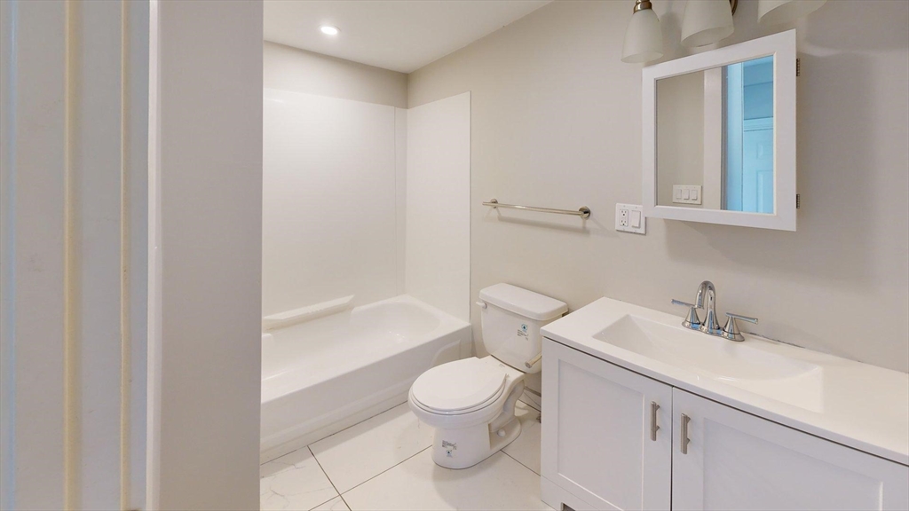 44 Morris Street, Unit 2 Boston, MA 02128 - Photo 16 of 23 a bathroom with a toilet a sink and a bathtub