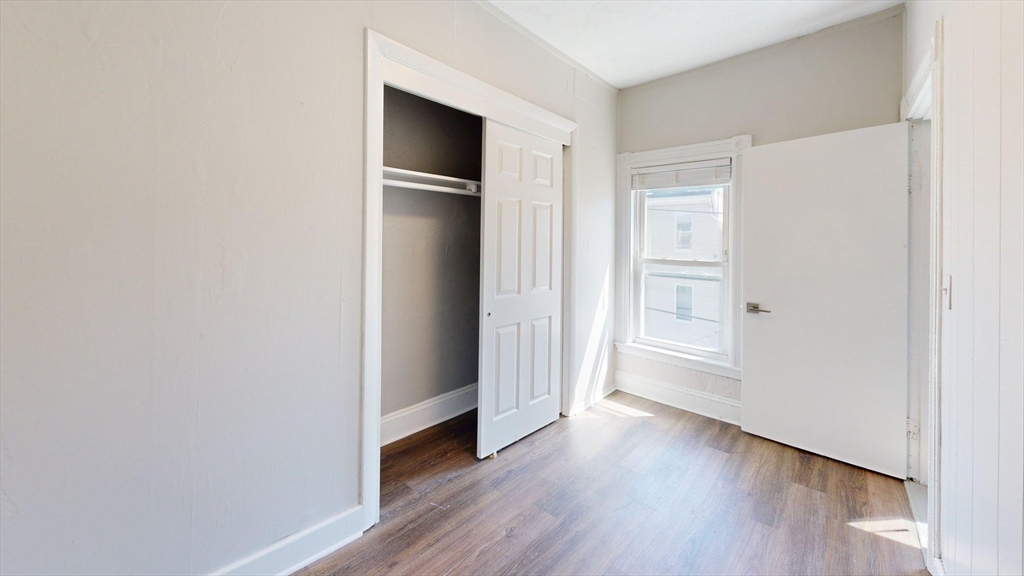 44 Morris Street, Unit 2 Boston, MA 02128 - Photo 18 of 23 a view of an empty room with wooden floor