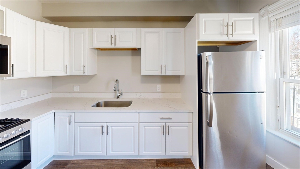 44 Morris Street, Unit 2 Boston, MA 02128 - Photo 23 of 23 a kitchen with refrigerator and cabinets