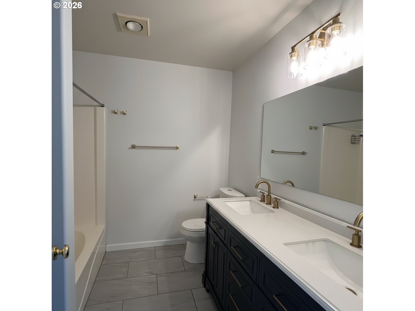 14110 Southwest Barrows Road, Unit 1 Portland, OR 97223 - Photo 12 of 18 a bathroom with a sink a toilet and shower