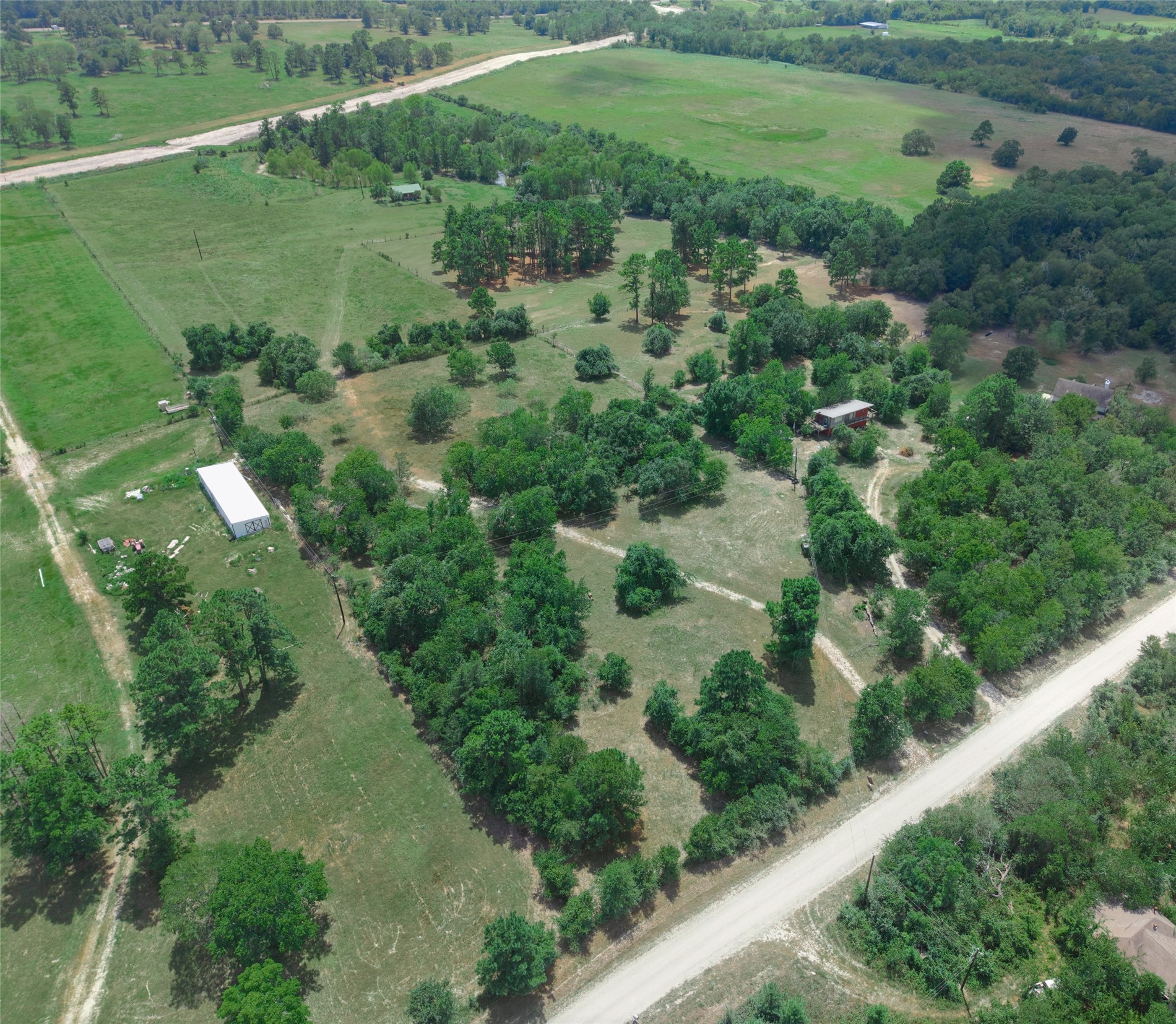 -tbd Davis Road Huntsville, TX 77340 - Photo 3 of 10 A wide aerial view captures the open land, mature trees, and easy access from the nearby road.