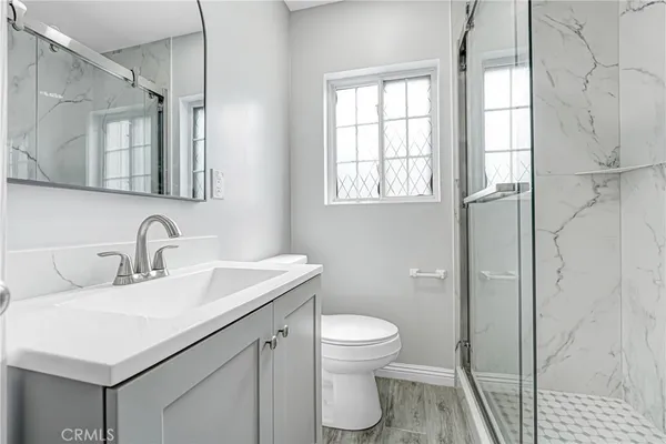 a bathroom with a sink toilet and shower