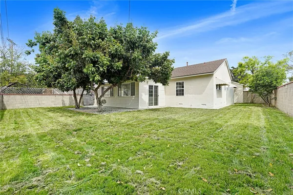 a view of house with backyard