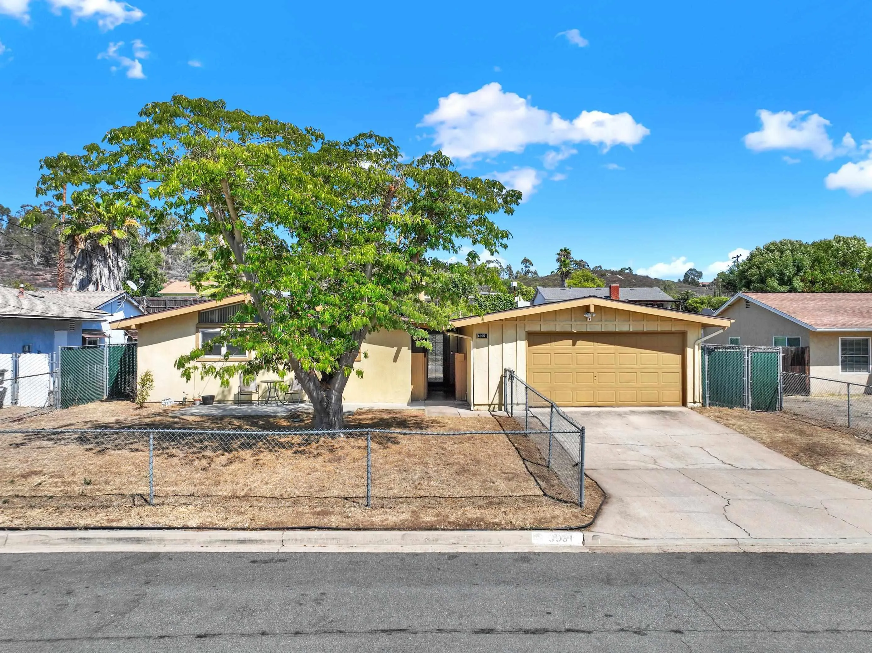 13951 Powers Road Poway, CA 92064 - Photo 1 of 27 a front view of a house with a yard and garage