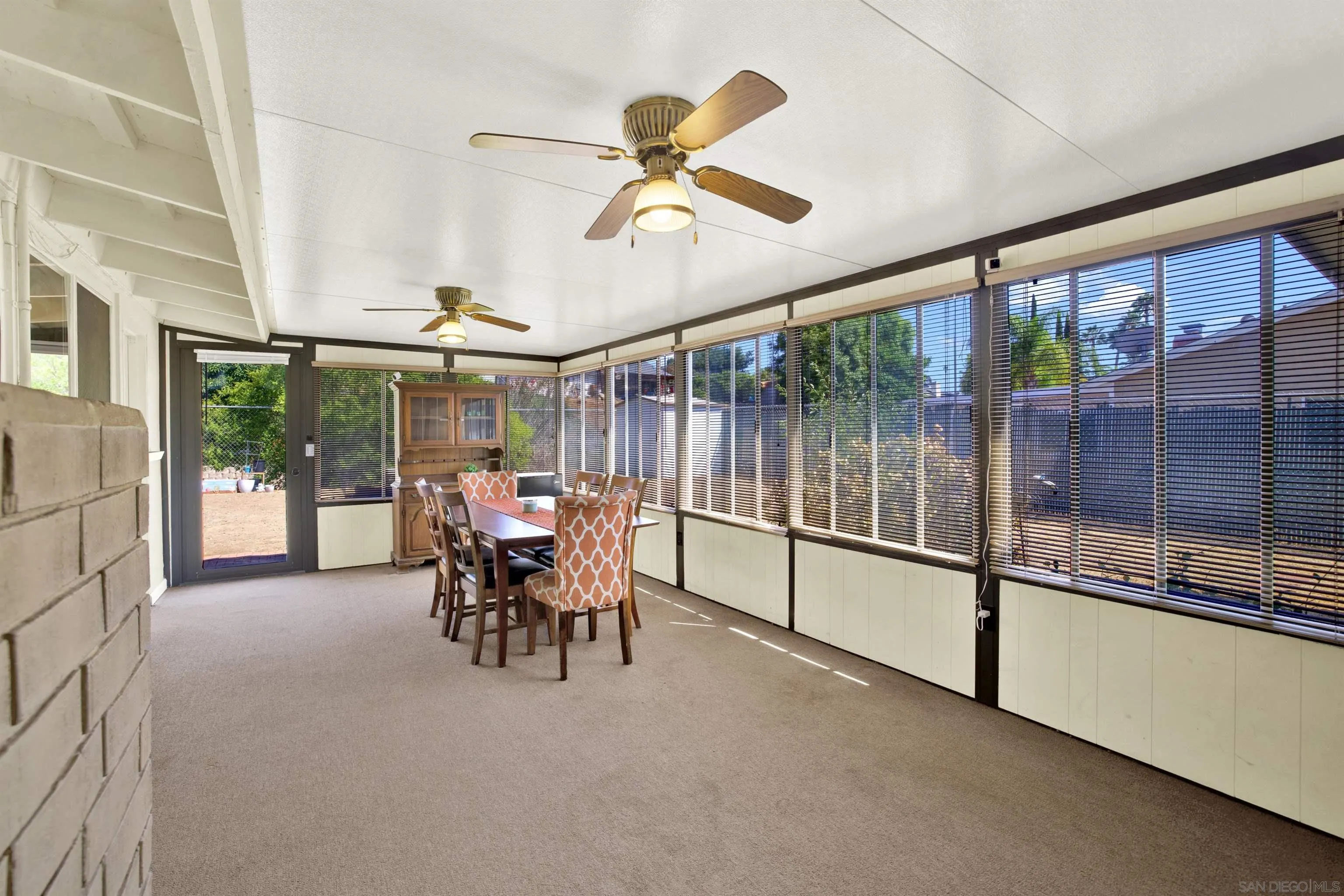 13951 Powers Road Poway, CA 92064 - Photo 13 of 27 a dining room with furniture a chandelier and fireplace