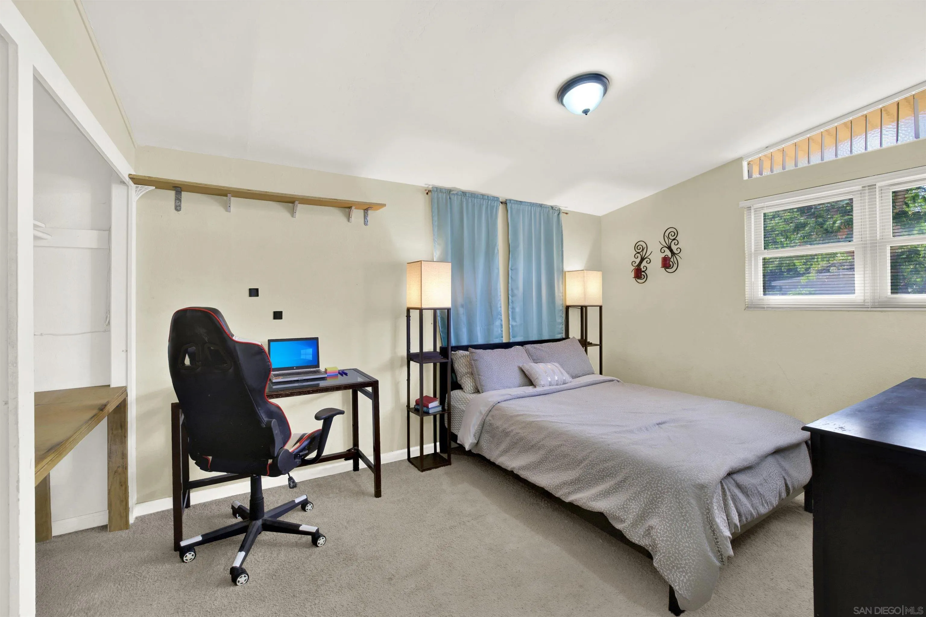 13951 Powers Road Poway, CA 92064 - Photo 16 of 27 a bedroom with a bed a chair and a window