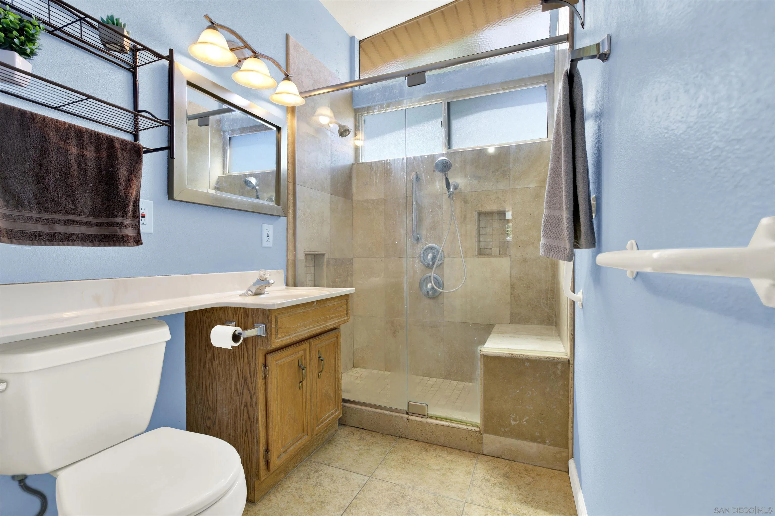 13951 Powers Road Poway, CA 92064 - Photo 17 of 27 a bathroom with a sink a toilet and shower