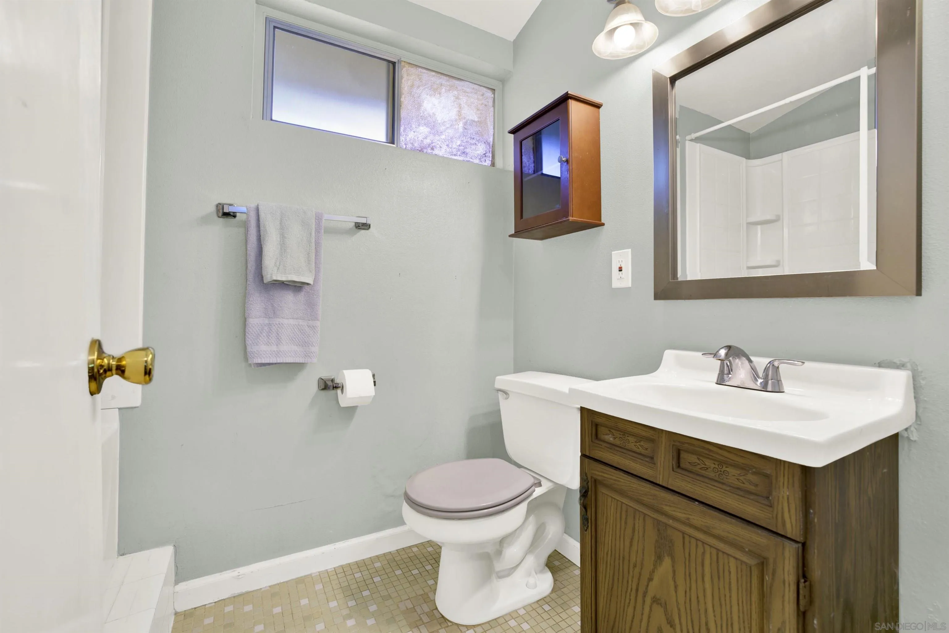 13951 Powers Road Poway, CA 92064 - Photo 20 of 27 a bathroom with a sink vanity mirror and toilet