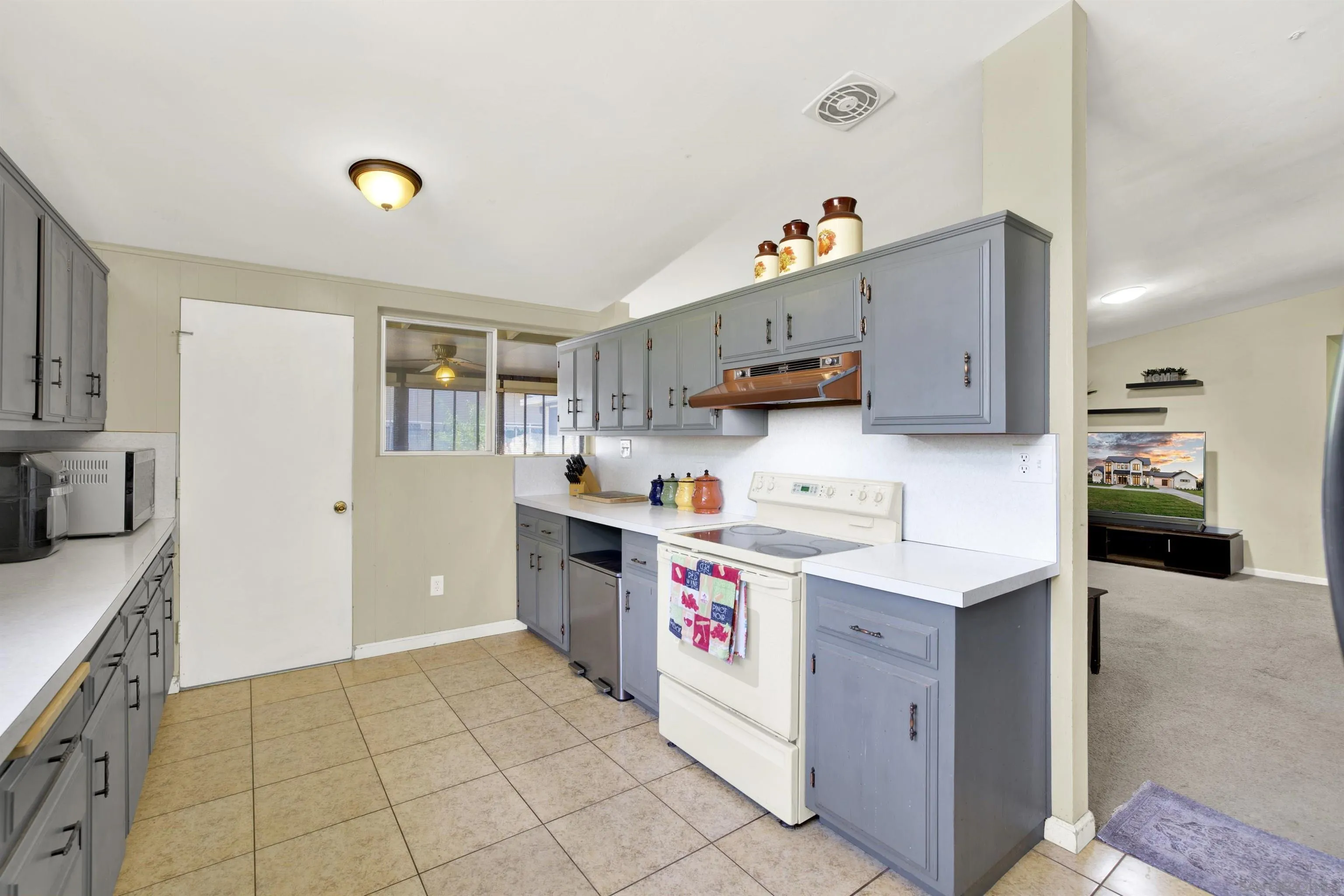 13951 Powers Road Poway, CA 92064 - Photo 3 of 27 a kitchen with kitchen island a sink stove and refrigerator