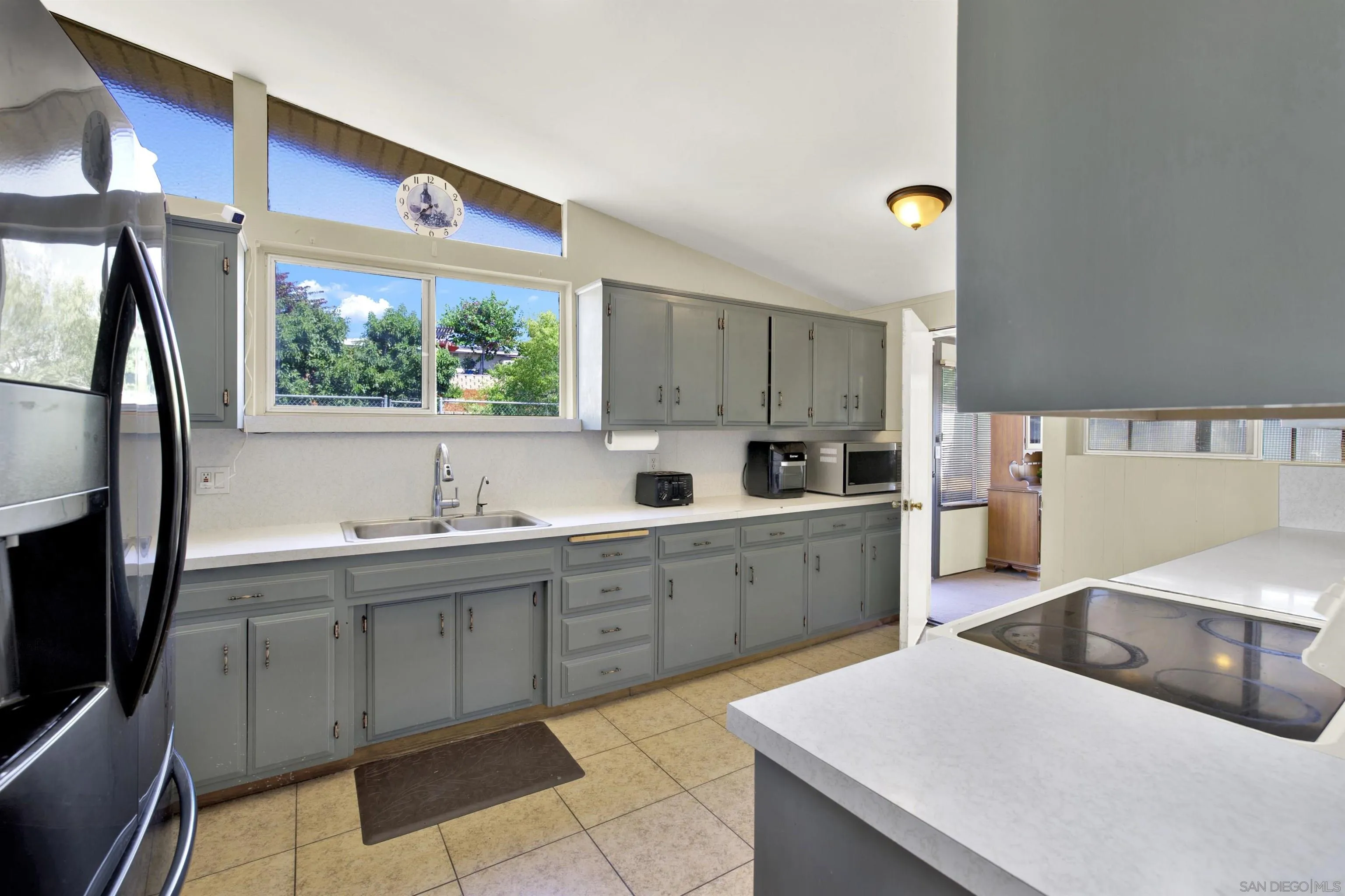 13951 Powers Road Poway, CA 92064 - Photo 5 of 27 a kitchen with a sink window and cabinets