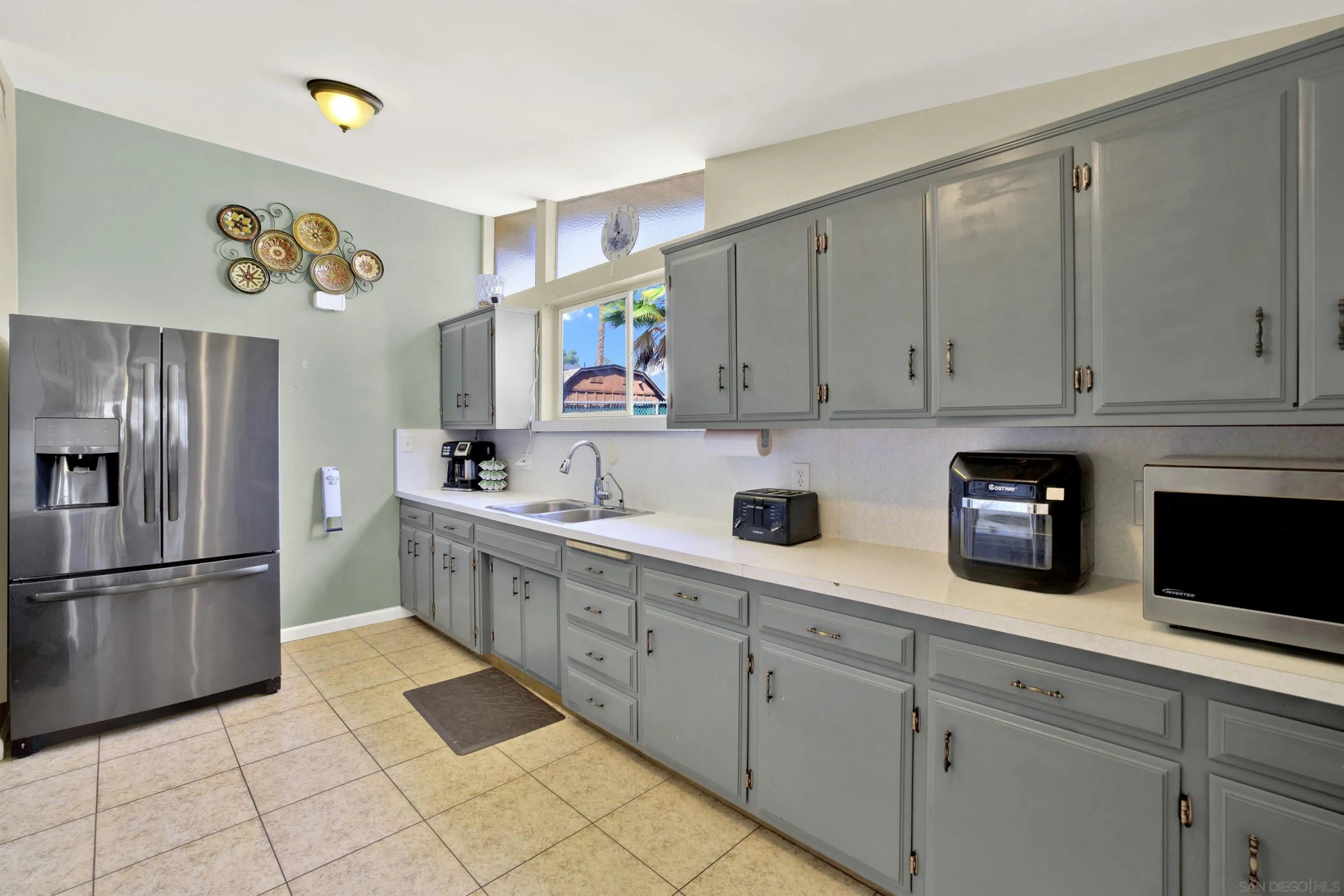 13951 Powers Road Poway, CA 92064 - Photo 6 of 27 a kitchen with stainless steel appliances granite countertop a refrigerator and a sink