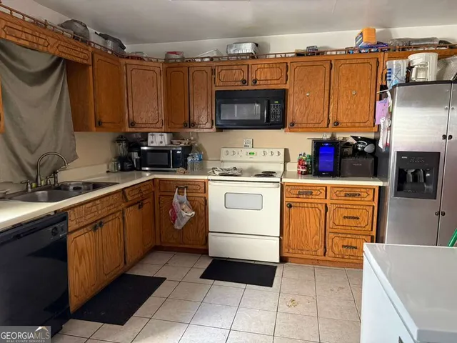 a kitchen with a sink stove and microwave