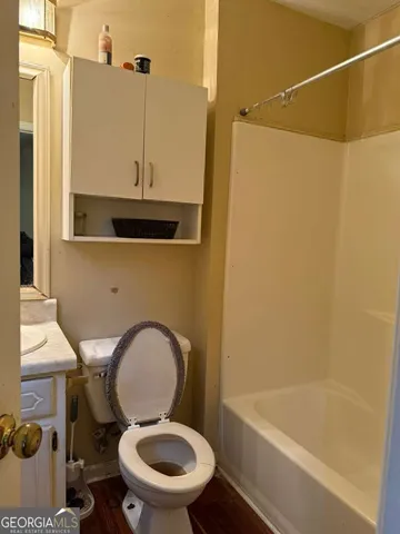 a bathroom with a toilet and a bathtub