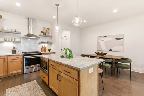 a kitchen with a table and chairs in it