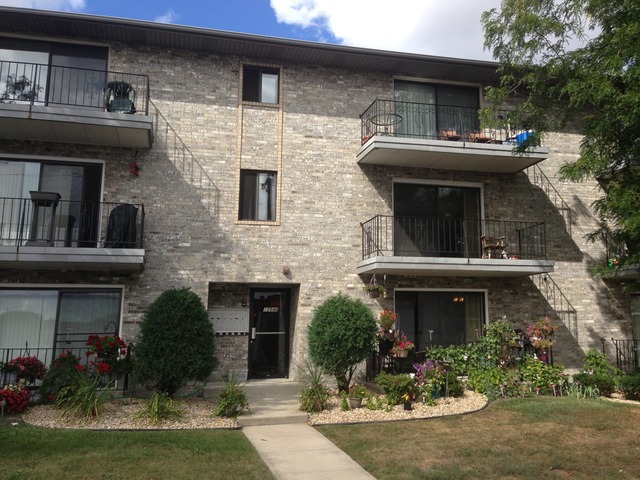 10944 Central Avenue, Unit 2A Chicago Ridge, IL 60415 - Photo 1 of 8 a front view of a house with garden