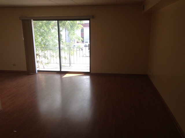 10944 Central Avenue, Unit 2A Chicago Ridge, IL 60415 - Photo 2 of 8 a view of an empty room with wooden floor and a window