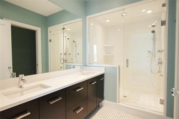 a bathroom with a granite countertop sink shower and a mirror