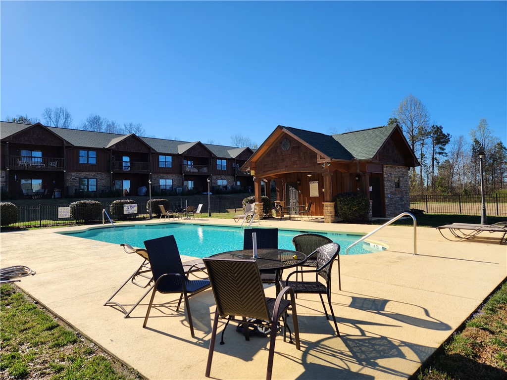 312 Killdevil Hill, Unit A Six Mile, SC 29682 - Photo 4 of 44 Pool side tables and chairs.
