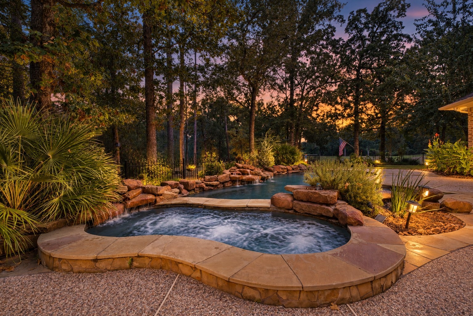 25119 Arcane Court Spring, TX 77389 - Photo 46 of 50 So Much More Than a Pool! Soak up the sun on expansive pool decking, enjoy the generous lawn for outdoor fun, or slip into the spa on cooler Texas evenings. When the temperature dips, step from the spa and warm up fireside beneath the covered porch—the perfect finish to a relaxing evening at home.
