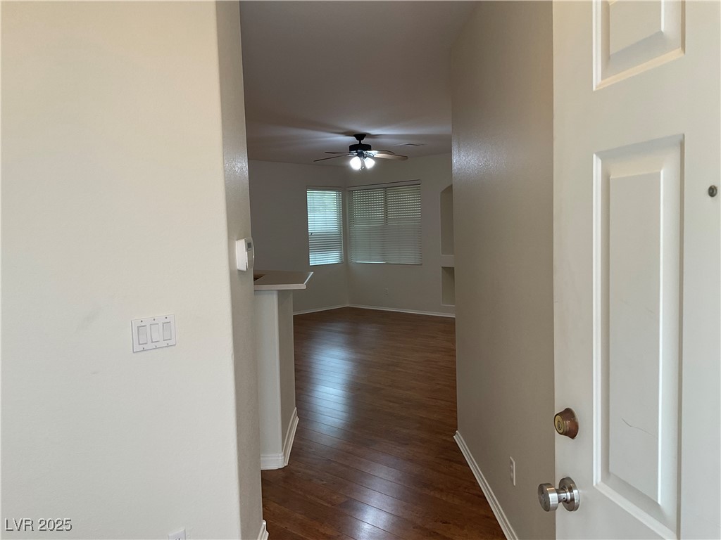 7620 Donald Nelson Avenue Las Vegas, NV 89131 - Photo 19 of 34 Hallway featuring dark wood-style flooring and baseboards