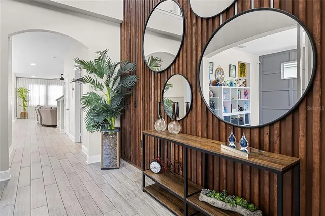 a view of staircase with wooden floor and a mirror