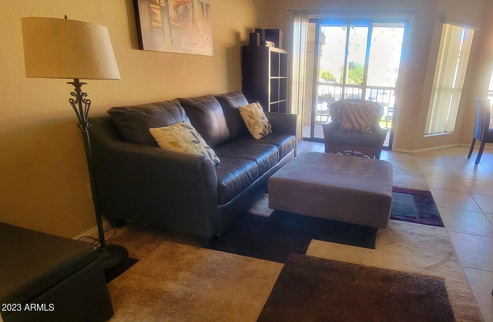 9711 East Mountain View Road, Unit 2500 Scottsdale, AZ 85258 - Photo 11 of 17 a living room with furniture and a window