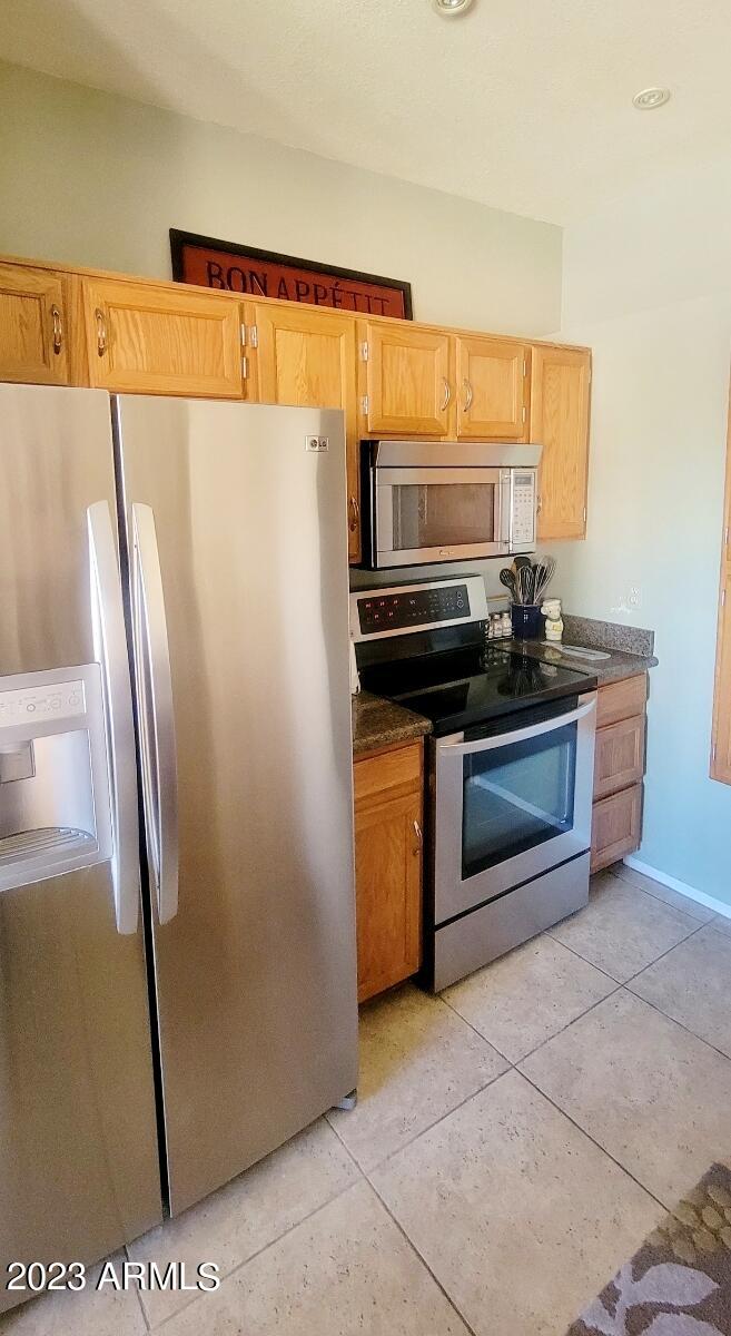9711 East Mountain View Road, Unit 2500 Scottsdale, AZ 85258 - Photo 14 of 17 a kitchen with stainless steel appliances granite countertop a refrigerator and a stove