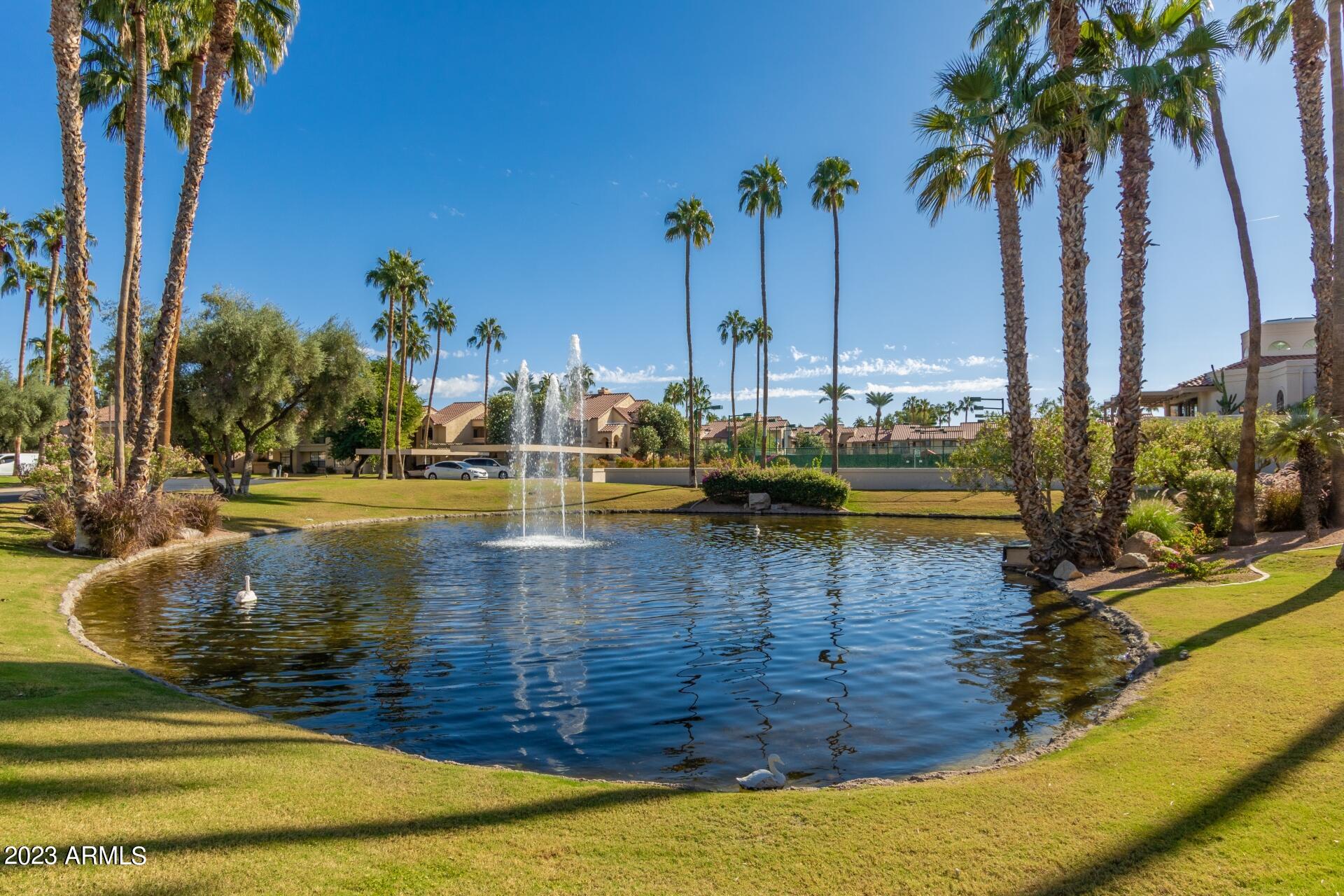 9711 East Mountain View Road, Unit 2500 Scottsdale, AZ 85258 - Photo 10 of 17 a view of a swimming pool with a table and chairs