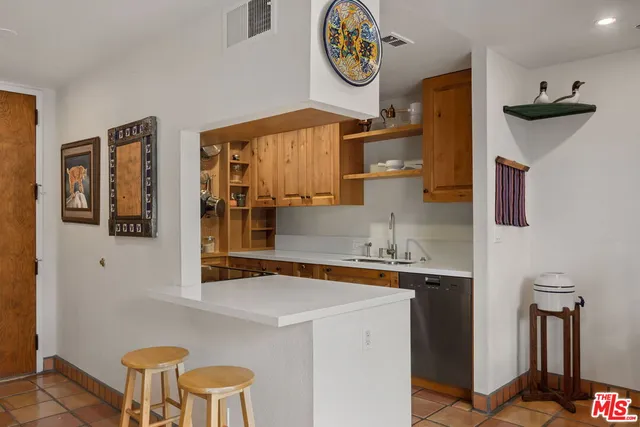 a kitchen with a refrigerator and a stove