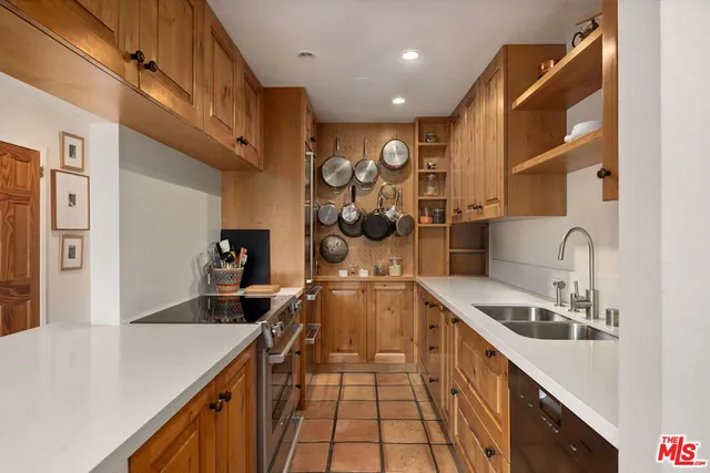 a kitchen with a sink appliances and cabinets