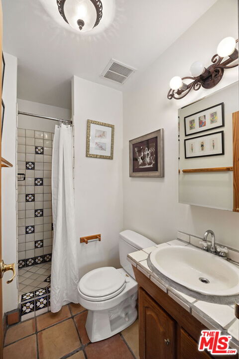 100 South Doheny Drive, Unit 214 Los Angeles, CA 90048 - Photo 7 of 17 a bathroom with a sink a toilet and shower