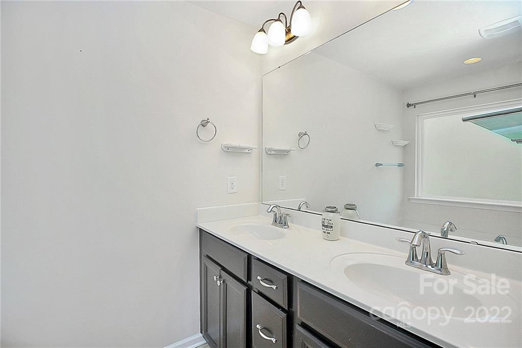 78134 Rillstone Drive Lancaster, SC 29720 - Photo 21 of 26 a bathroom with a sink and a mirror
