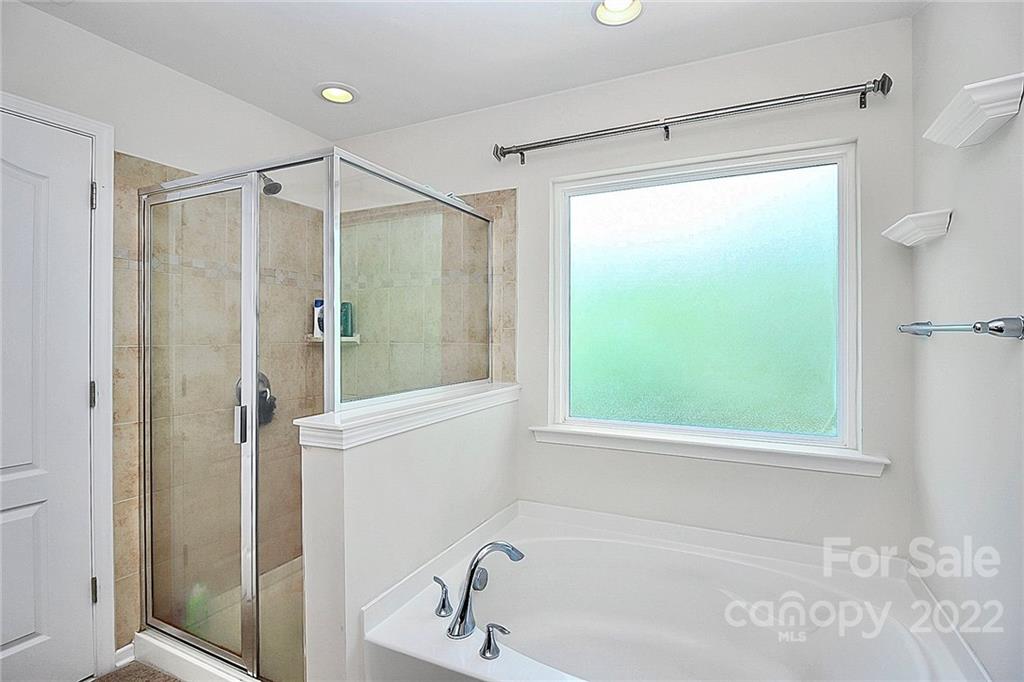 78134 Rillstone Drive Lancaster, SC 29720 - Photo 22 of 26 a bathroom with a bathtub and a shower