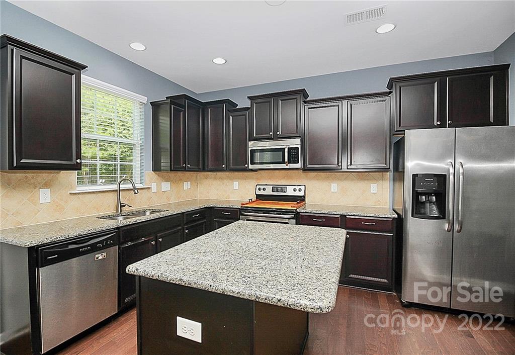 78134 Rillstone Drive Lancaster, SC 29720 - Photo 6 of 26 a kitchen with stainless steel appliances granite countertop a sink stove and refrigerator
