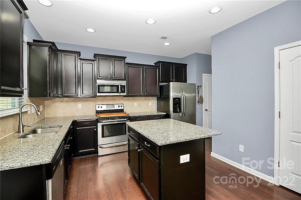 78134 Rillstone Drive Lancaster, SC 29720 - Photo 7 of 26 a kitchen with stainless steel appliances granite countertop a sink stove and refrigerator