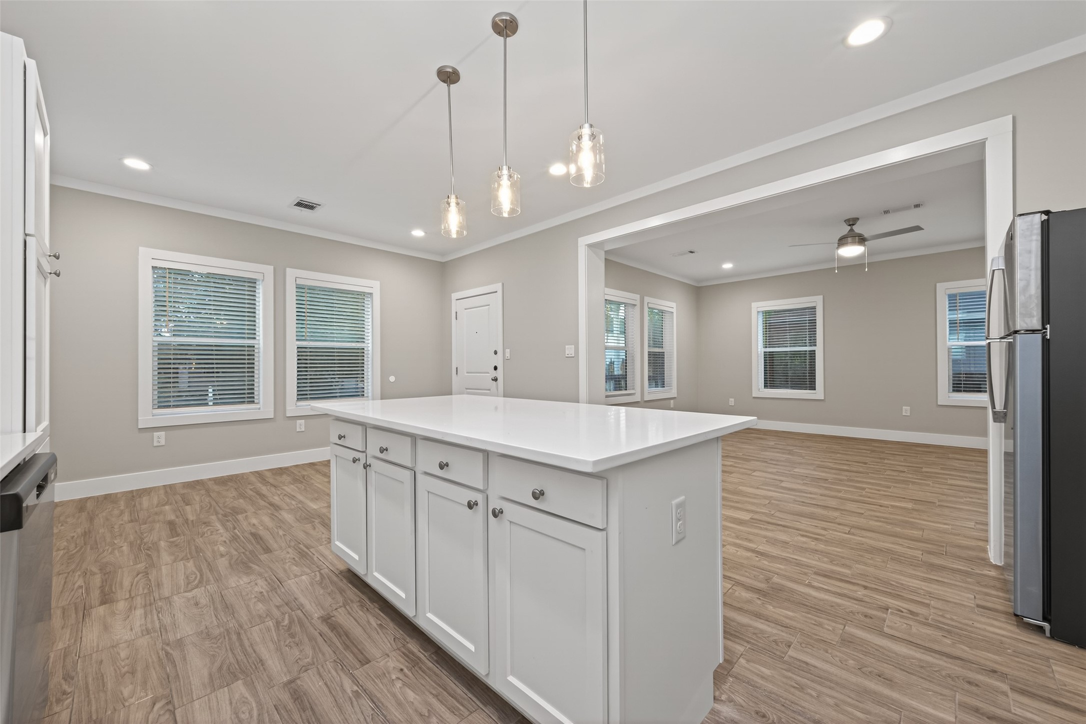 6605 Greenhurst Street Houston, TX 77091 - Photo 14 of 41 a large kitchen with kitchen island a large island wooden floor and stainless steel appliances