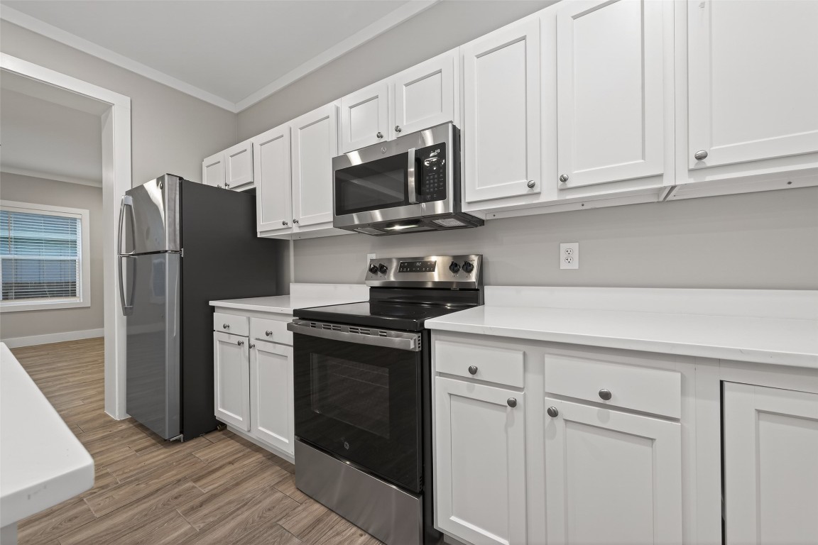 6605 Greenhurst Street Houston, TX 77091 - Photo 2 of 41 a kitchen with stainless steel appliances granite countertop white cabinets a refrigerator and a stove top oven