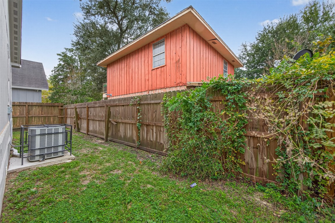 6605 Greenhurst Street Houston, TX 77091 - Photo 41 of 41 a view of backyard with small cabin and wooden fence