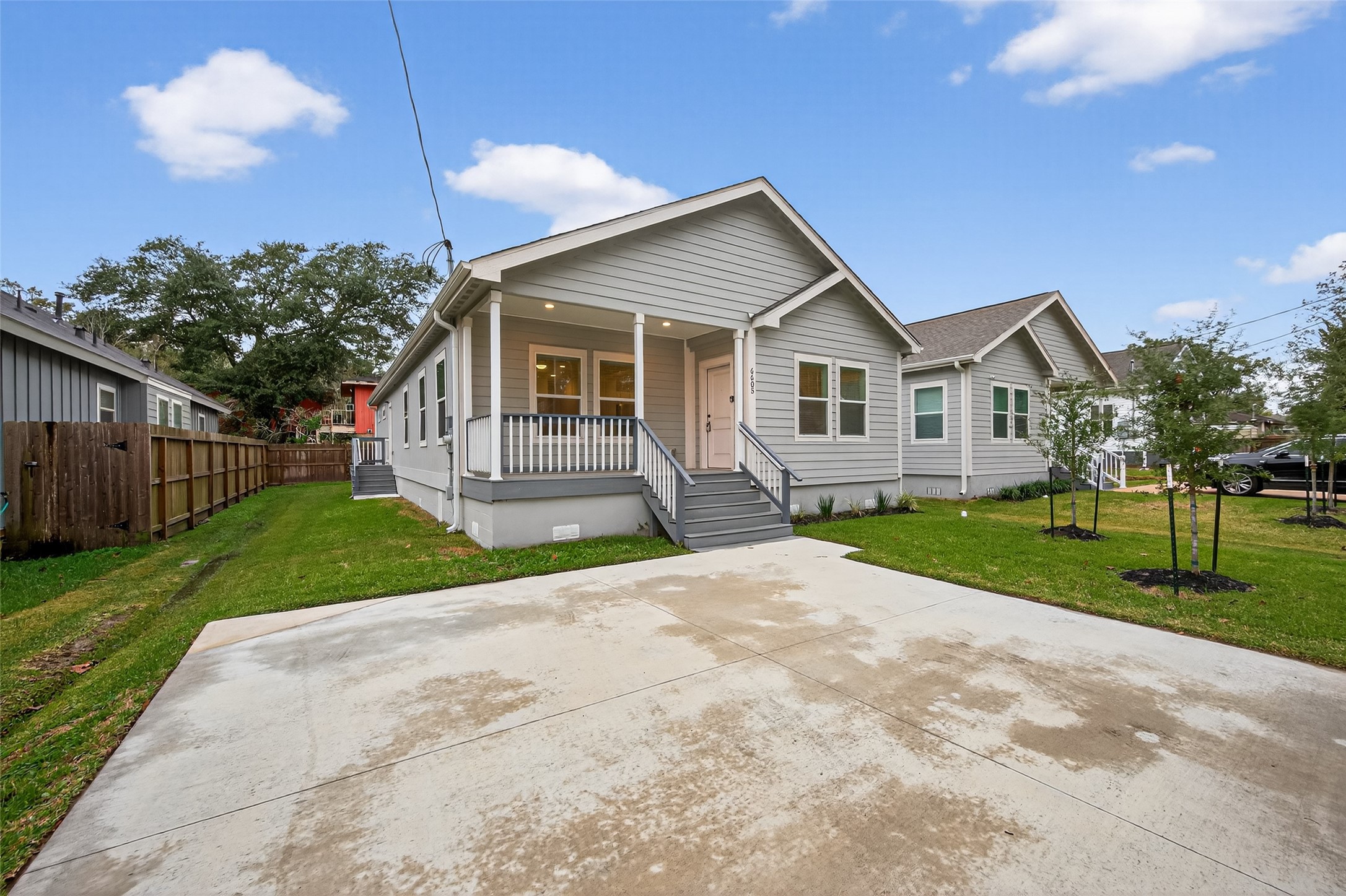 6605 Greenhurst Street Houston, TX 77091 - Photo 7 of 41 a view of a house next to a yard with big trees