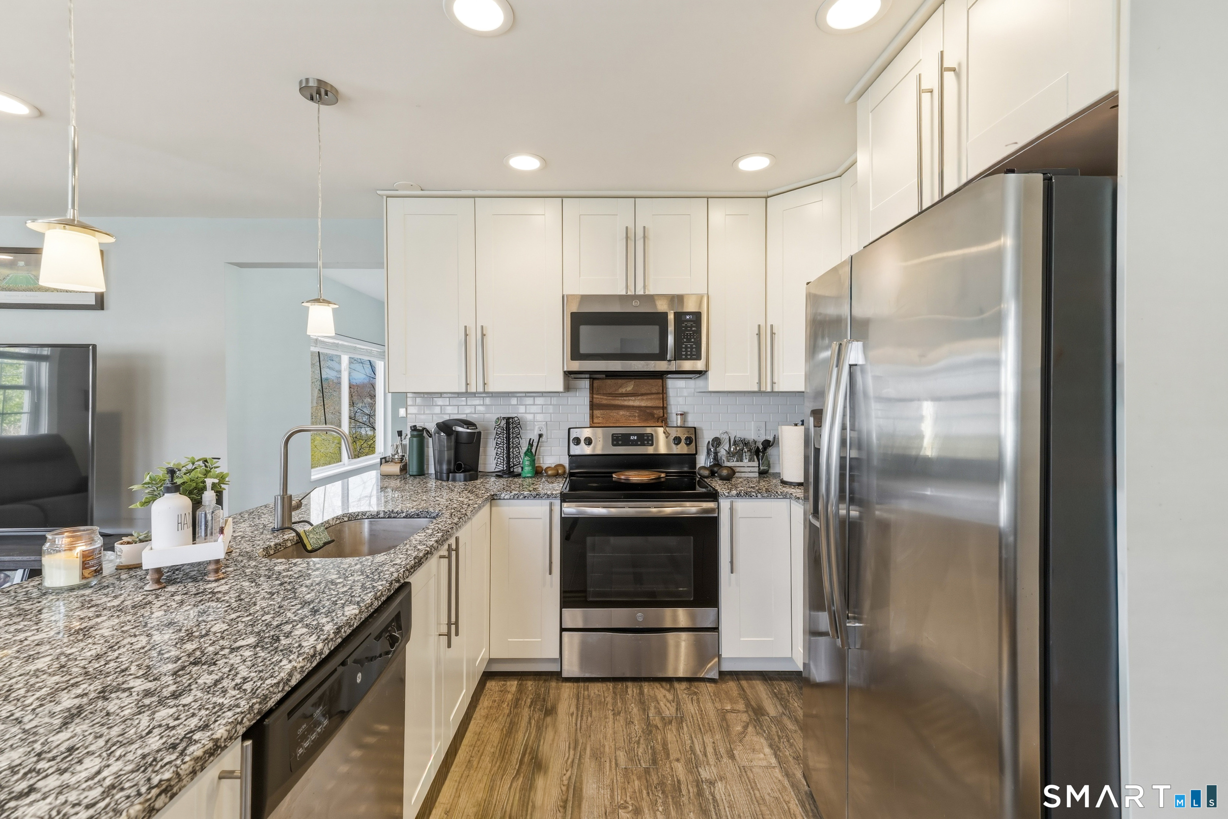 15 Cedar Avenue Wolcott, CT 06716 - Photo 8 of 31 a kitchen with a refrigerator sink and stainless steel appliances