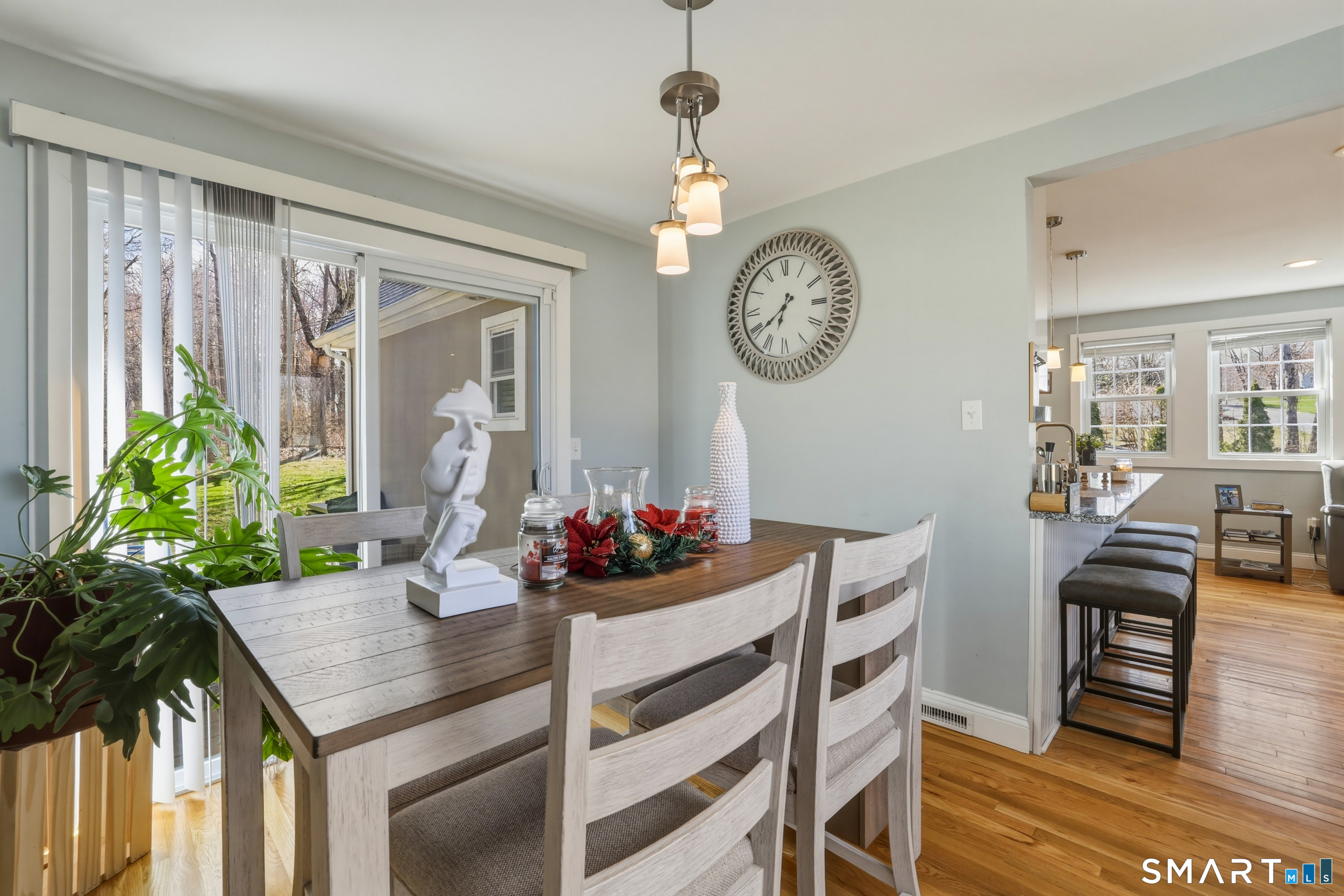 15 Cedar Avenue Wolcott, CT 06716 - Photo 10 of 31 a view of a dining room and kitchen with furniture a chandelier and wooden floor