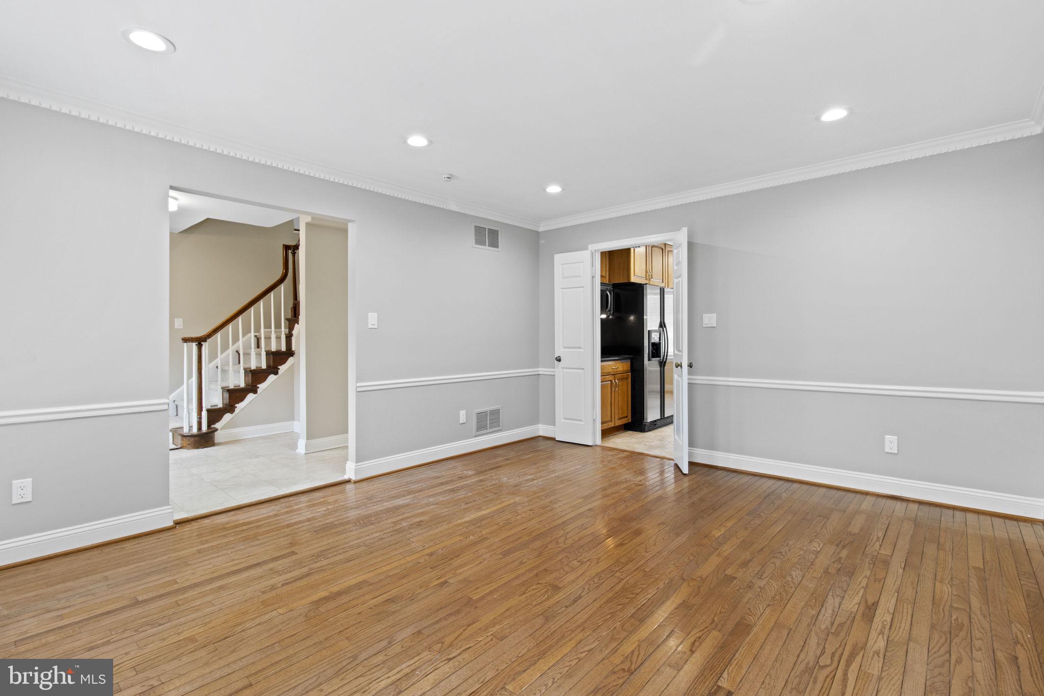 8800 Seven Locks Road Bethesda, MD 20817 - Photo 11 of 33 wooden floor in an empty room with a window