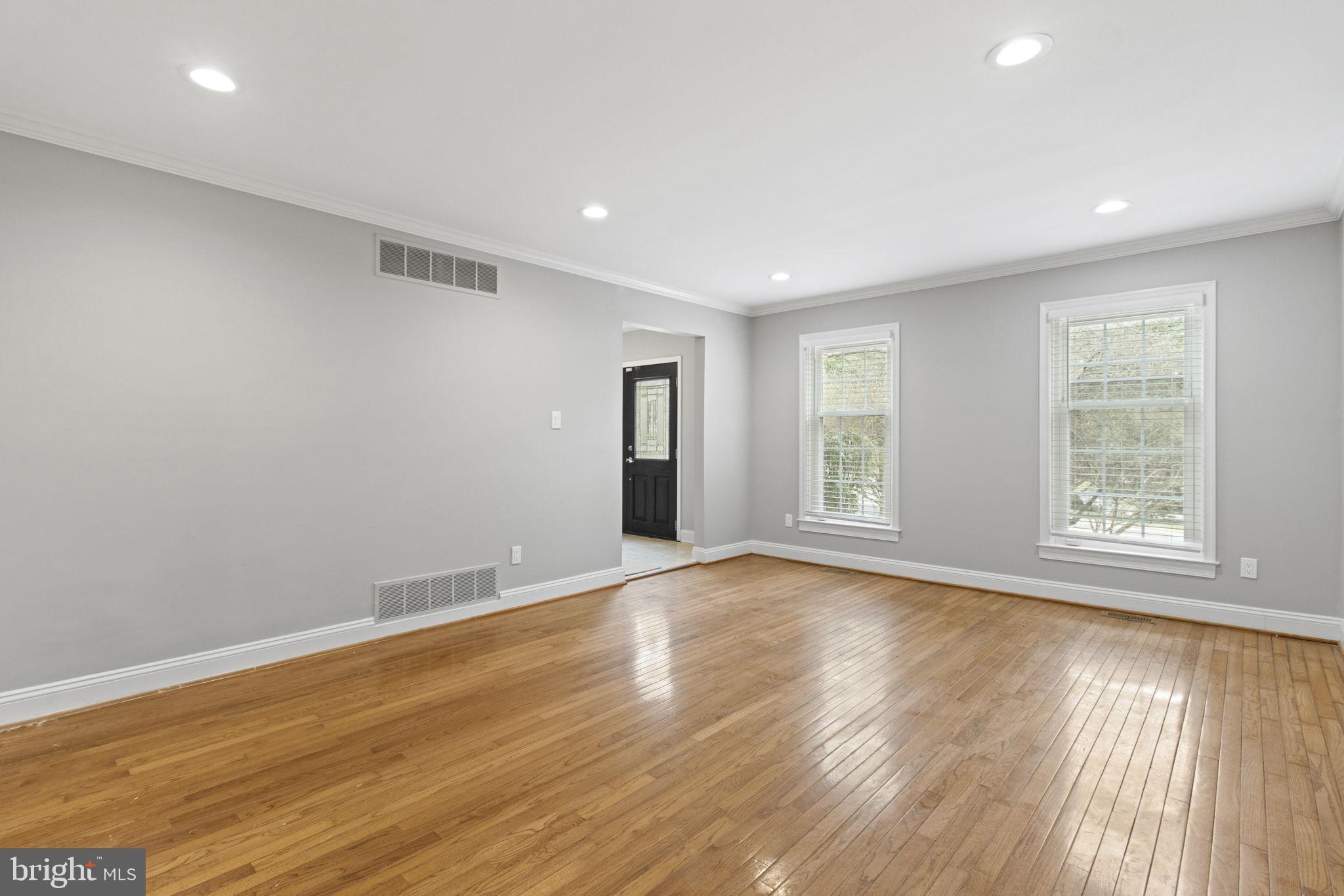 8800 Seven Locks Road Bethesda, MD 20817 - Photo 12 of 33 an empty room with wooden floor and windows