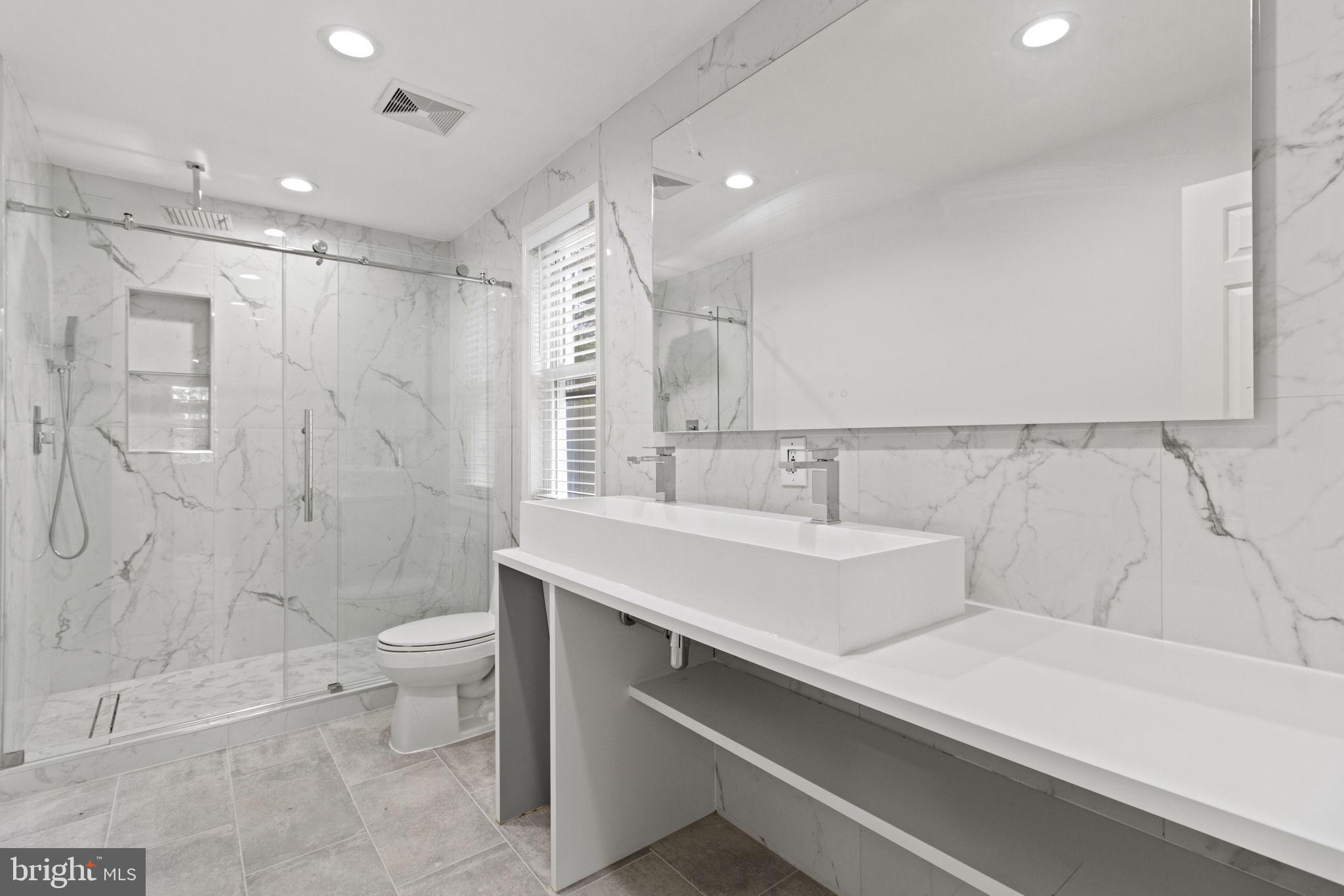 8800 Seven Locks Road Bethesda, MD 20817 - Photo 17 of 33 a bathroom with a sink a toilet and shower