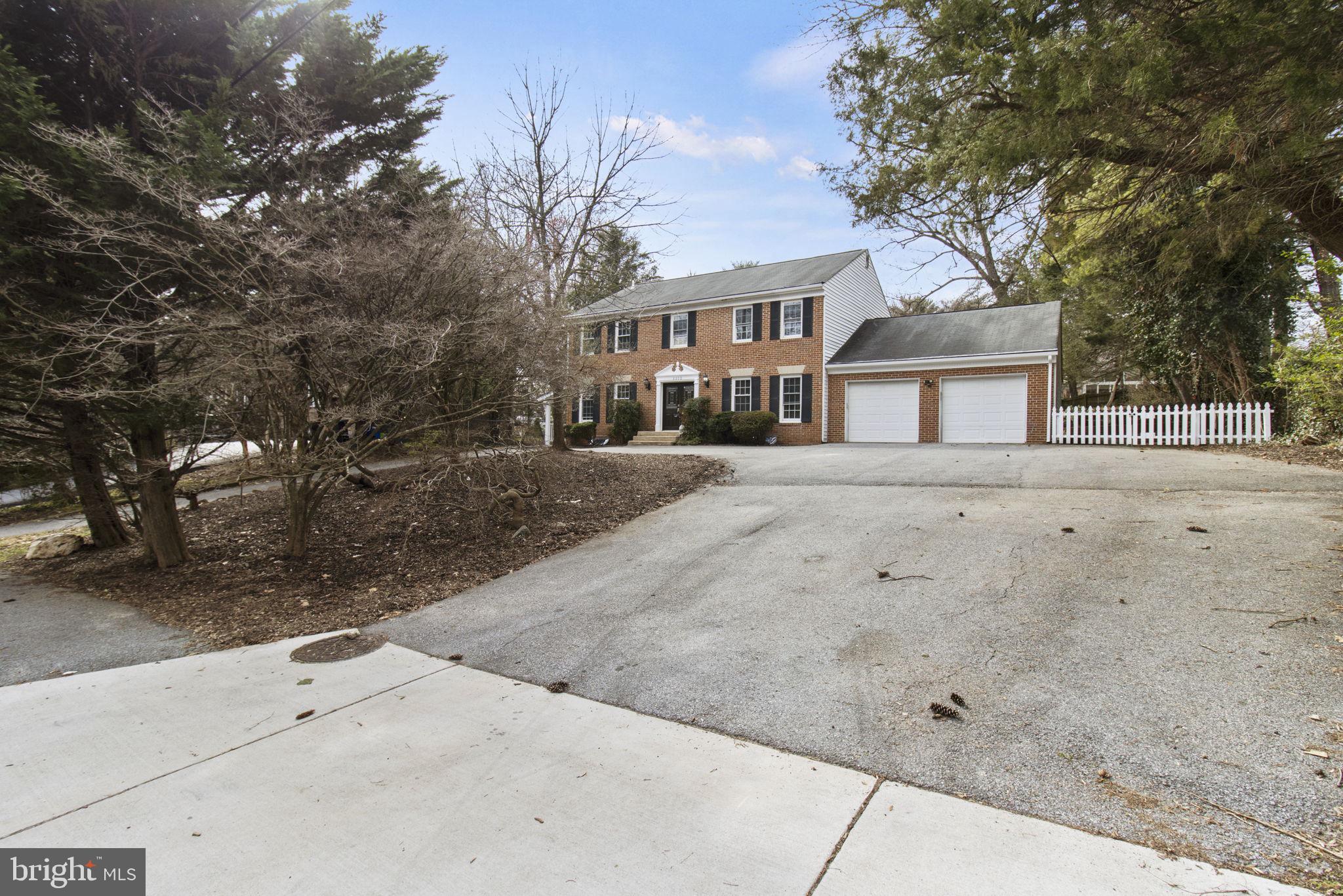 8800 Seven Locks Road Bethesda, MD 20817 - Photo 2 of 33 a front view of a house with a yard and garage
