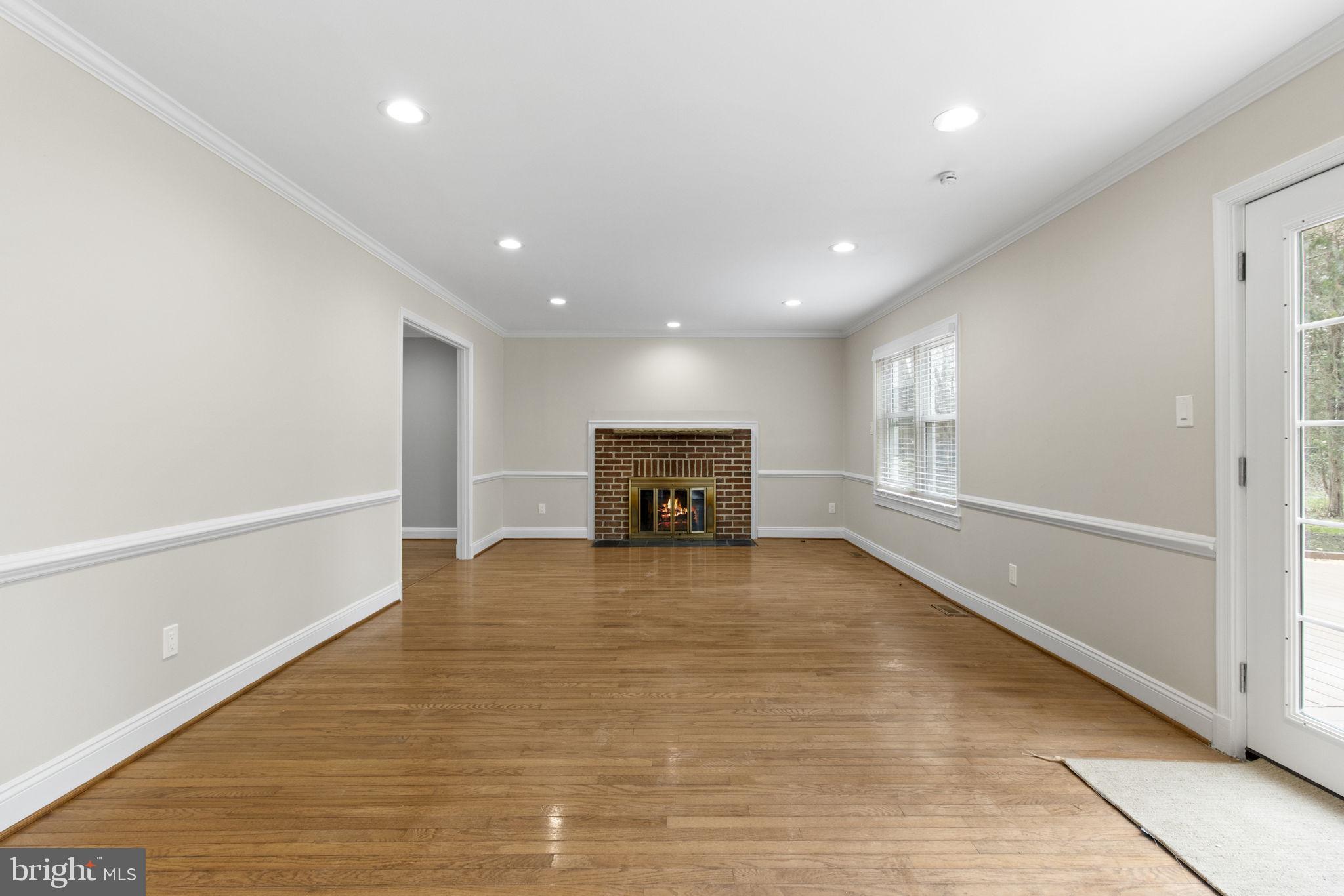 8800 Seven Locks Road Bethesda, MD 20817 - Photo 9 of 33 a view of an empty room with a window and fireplace