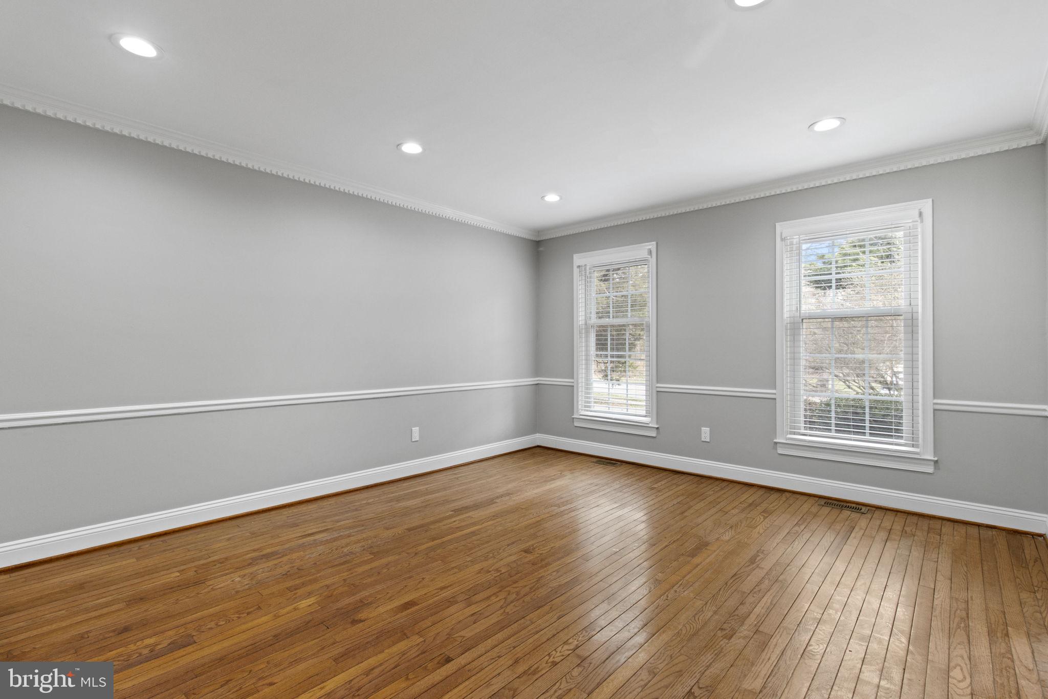 8800 Seven Locks Road Bethesda, MD 20817 - Photo 10 of 33 an empty room with wooden floor and windows