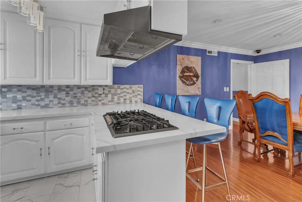1324 East Turmont Street Carson, CA 90746 - Photo 18 of 47 a kitchen with stainless steel appliances granite countertop a stove a sink and a microwave