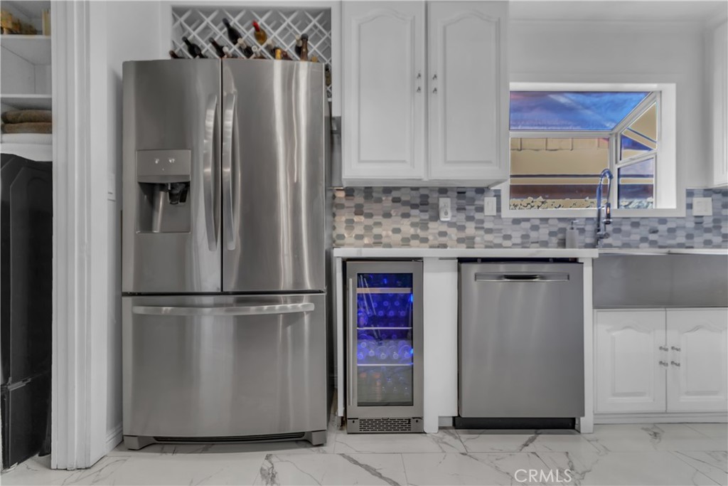 1324 East Turmont Street Carson, CA 90746 - Photo 19 of 47 a kitchen with stainless steel appliances granite countertop a refrigerator a stove and a sink