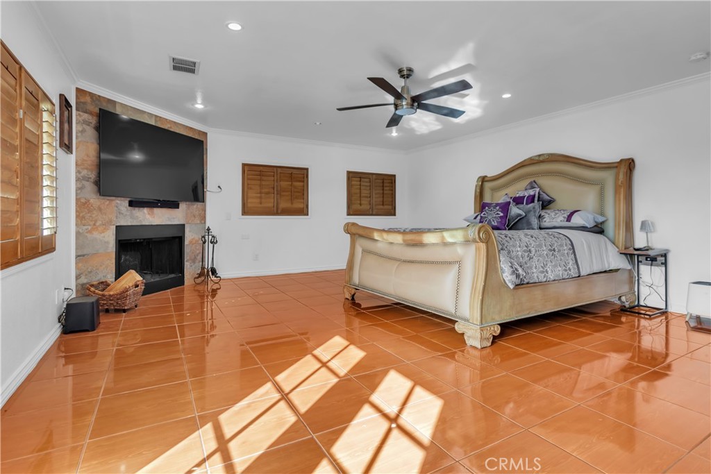 1324 East Turmont Street Carson, CA 90746 - Photo 37 of 47 a spacious bedroom with a bed and a flat screen tv